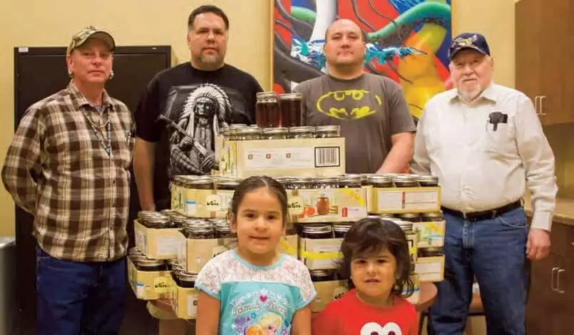Workers standing together with the finished maple syrup. (back l-r) Brian Franz, Greg Kitchell, Jamie Tuckwab and Billy Daniels Jr. (front l-r) Breana and Calvin Kitchell. Both great helpers in making this year’s syrup. Nathan Morris not present at time of photo.