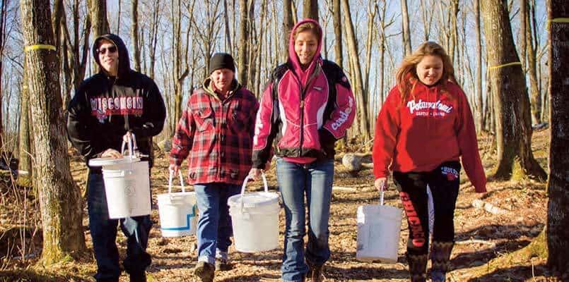 Students from Wabeno High School language class learn about the art of making maple syrup. (l-r) Kordell VanZile, Brian Franz, FCP Language & Culture teacher/apprentice; Holly Spaude and Monique Tuckwab.