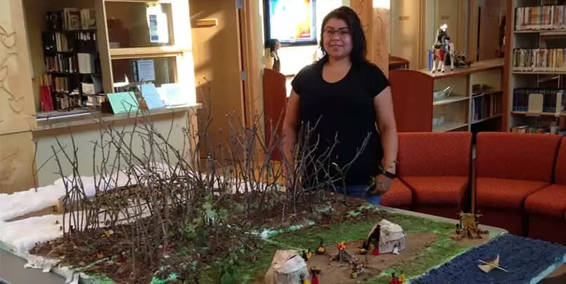 Candace Skenandore standing behind the finished project.